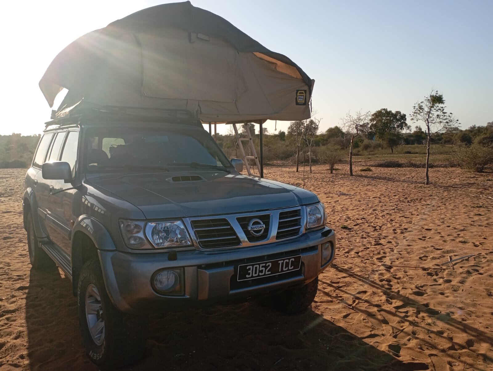 4wdmada Nissan Patrol with an open rooftop tent on a sandy track
